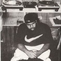 a man sitting in front of record players