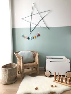 a baby's room with a rocking chair, crib and wooden toys on the floor