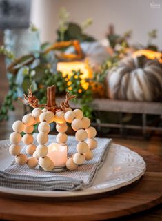 a white plate topped with lots of food on top of a wooden table next to a potted plant