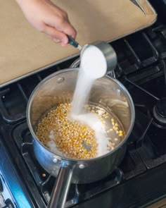 a person is stirring something in a pot on the stove