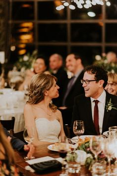 a man and woman sitting at a dinner table