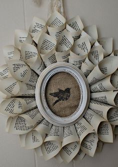 an old book page wreath with a bird on it