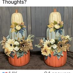 two pumpkins decorated with flowers and leaves