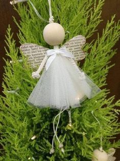 an angel ornament on top of a christmas tree