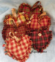 four red and yellow plaid heart shaped ornaments