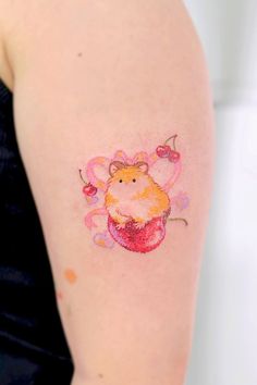 a woman with a tattoo on her arm that has a hamster in the center