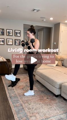 a woman is doing exercises in her living room