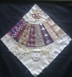 a piece of cloth has been stitched together with different colors and designs on it