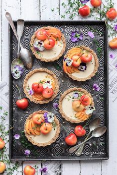 small tarts with fruit and flowers on top