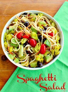 a white bowl filled with pasta salad on top of a green napkin