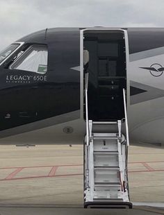 an airplane door is open on the tarmac with stairs leading up to it's landing area