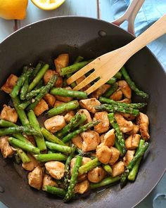 chicken and asparagus stir fry in a pan