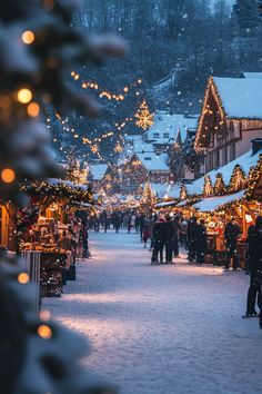 people are walking around in the snow near christmas decorations and lights on buildings with trees