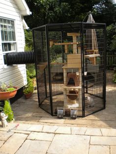 a large bird cage sitting on top of a patio