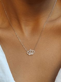 Beautiful crown for beautiful queens👑 Get this beautiful minimalist jewelry made with the quality of perfect elements✨ You can choose 925K Sterling Silver with the options of Gold, Rose Gold or White Gold colors as well as 14K solid Gold material. High quality jewelry for everyone 🤍  Details * 925K Sterling Silver Option → 14K Gold, Rose Gold or White Gold plated * 14K Gold Option → approximately 2.50 gram * Chain length is approximately 18 inches (16+2 in extender) / 45 cm (40+5 cm extender) * Time is everything! You will receive your package as soon as possible 🚚  * We care about the quality of metal to make sure it will last for a long time * We use enamel technique to color the jewelry and high quality zircons only * There can be tiny differences on each item. Length difference of t Gold Crown Necklace, Silver Dainty Jewelry With Crown Design, Dainty Silver Jewelry With Crown Design, Elegant Crown Design Necklace For Wedding, Dainty Jewelry With Crown Design As Gift, Dainty Jewelry With Crown Design For Gift, Elegant Crown Pendant Jewelry, Silver Jewelry With Crown Design In 14k Gold, Elegant Crown Design Necklace For Gift