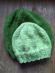 a green knitted hat sitting on top of a wooden floor