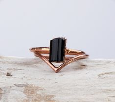 MAEVE - Raw Black Tourmaline ring set A bold black engagement ring highlighted by a simple yet elegant chevron band. Features a lush black tourmaline left in its raw, naturally beautiful shape and set on a sustainable and charming copper base. Handcrafted out of ethical and sustainable materials, each piece is a one-of-a-kind and uniquely yours. DETAILS *Raw high grade black Tourmaline *Pure copper base with thick (10 micron) plating options in Silver, Gold, Rose gold. MADE SPECIALLY FOR YOU! Wh Raw Crystal Engagement Rings Black, Black Tourmaline Gemstone Rings, Black Engagement Ring Set, Black Rutile Quartz Engagement Ring, Raw Stone Engagement Rings, Black Tourmaline Ring, Tourmaline Engagement Ring, Ring Enhancer, Raw Black Tourmaline