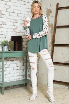 Pretty blooms pop on the raglan sleeves of a top that you'll want to pair with everything. Material: 87% polyester 10% rayon 3% spandex Stretch: Slightly stretchy Care: Machine wash cold, gentle cycle, do not bleach, tumble dry low. Made in USA Product Measurements S: 36.0-38.0” (Bust) M: 38.0-40.0” (Bust) L: 40.0-42.0” (Bust) Spring Tops With Contrast Long Sleeves, Spring Top With Long Contrast Sleeves, Spring Cotton Top With Raglan Sleeves, Spring Tops With Contrast Sleeves And Long Sleeve, Spring Cotton Raglan Sleeve Tops, Long Sleeve Tops With Contrast Sleeves For Spring, Green Stretch Long Sleeve Top For Spring, Summer Stretch Raglan Sleeve Tops, Casual Floral Print Tops For Loungewear