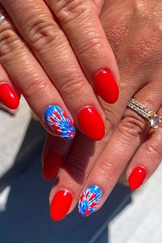 Celebrate Independence Day with these vibrant almond-shaped nails. The glossy red base pairs perfectly with the vivacious fireworks design in blue, white, and red, capturing the essence of Fourth of July festivities. These nails are a fun and stylish way to show off your patriotic spirit! 🎆🇺🇸  // Photo Credit: Instagram @weloveglitterdesign Almond Nails Fourth Of July, Groovy 4th Of July Nails, Red July Nails, Cute 4th Of July Nails Almond Shape, 4 Of July Nails Acrylic Almond, Chrome Fourth Of July Nails, Patriotic Almond Nails, Simple Fourth Of July Nails Almond, Simple Red White Blue Nails