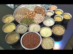 a table topped with bowls filled with different types of grains and seeds next to each other