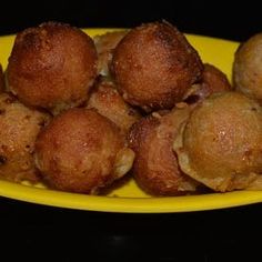 a yellow plate filled with fried food on top of a table