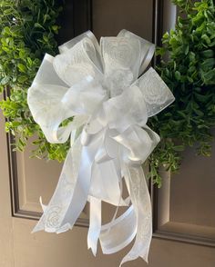 a white bow hanging on the front door