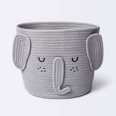 a grey basket with an elephant face on it