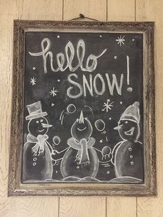 a chalkboard with the words hello snow written on it in front of two smiling snowmen