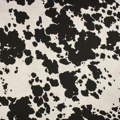 a black and white cow print area rug