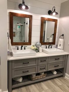 a bathroom with double sinks and two mirrors