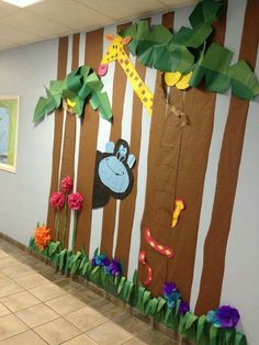 this is an image of a classroom wall decorated with paper jungle animals and giraffes