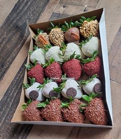 a box filled with chocolate covered strawberries and nuts