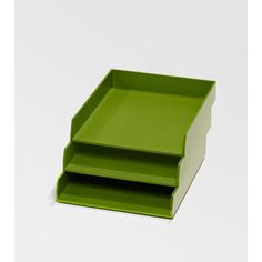 three green trays sitting on top of each other in front of a white background