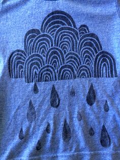 a blue shirt with rain drops on it