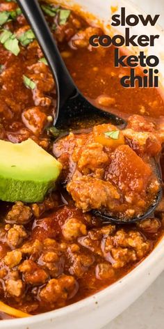 slow cooker keto chili with meat and avocado in a white bowl