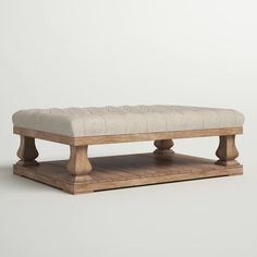 a wooden bench sitting on top of a hard wood floor