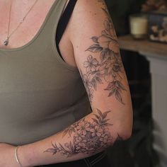 a woman with a flower tattoo on her arm