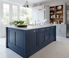 the front cover of a magazine with an image of a kitchen island and sink in it