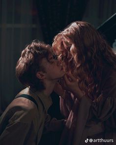 two people kissing each other in the dark