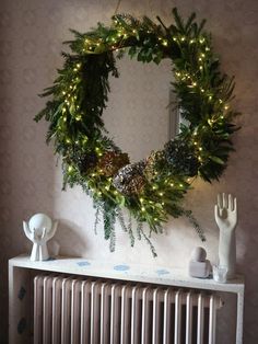 a wreath is hanging on the wall above a radiator