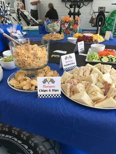 a blue table topped with plates of food