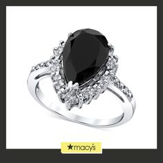 a black and white ring with diamonds on it's sides, the center stone is surrounded