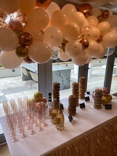 balloons and champagne bottles on a table at a party