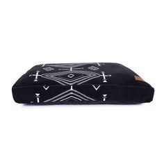 a black and white dog bed with geometric designs