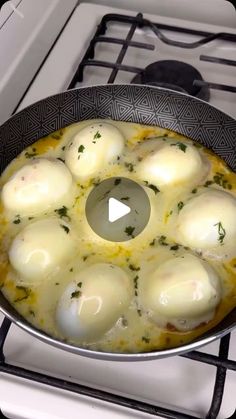 eggs are being cooked in a skillet on top of an oven burner,