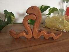 a wooden figure sitting on top of a table