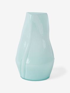 a blue vase sitting on top of a white table