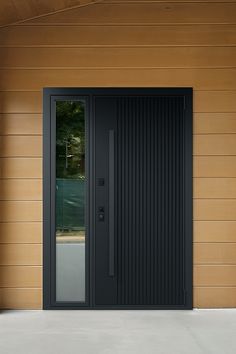 a black front door on a wooden wall