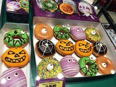 there are many decorated doughnuts on display in the box for people to see