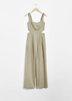 Sleeveless jumpsuit accented with cut-out detailing at the waist.• Square neckline• Smocked detailing at the back• Duo inseam pockets• Duo welt pockets at the back• Length of inseam:76cm / 29.9" (EU 36 / UK 8 / US 4) Casual Cutout Jumpsuits And Rompers For Spring, Casual Spring Jumpsuits And Rompers With Cutout, Summer Sleeveless Cutout Jumpsuits And Rompers, Sleeveless Jumpsuits And Rompers For Summer, Summer Style Guide, Green Jumpsuit, Skirt And Blouse, Sleeveless Jumpsuits, Fashion Story